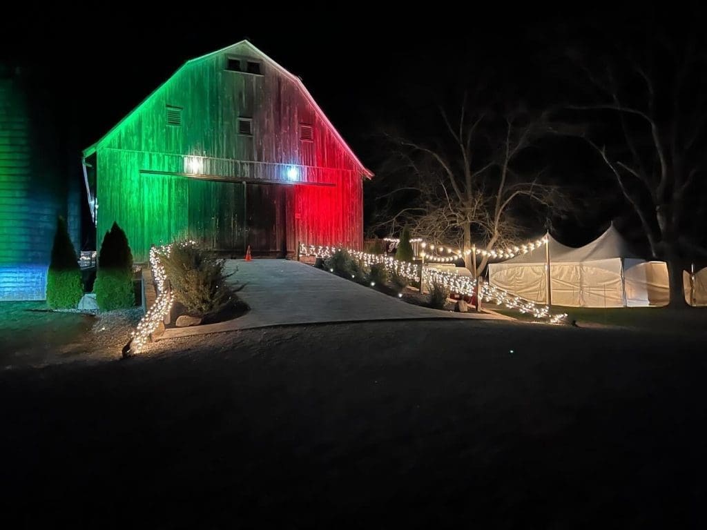 Barn lit up at night during a holiday event