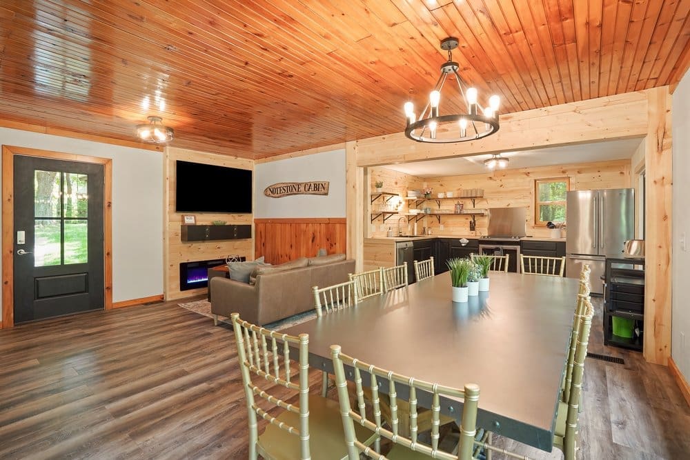 Spacious dining area inside Notestone Cabin with long table and wooden interior
