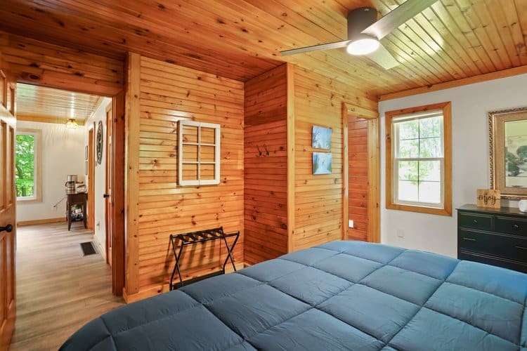 You will be welcomed into the master bedroom with pine accents.