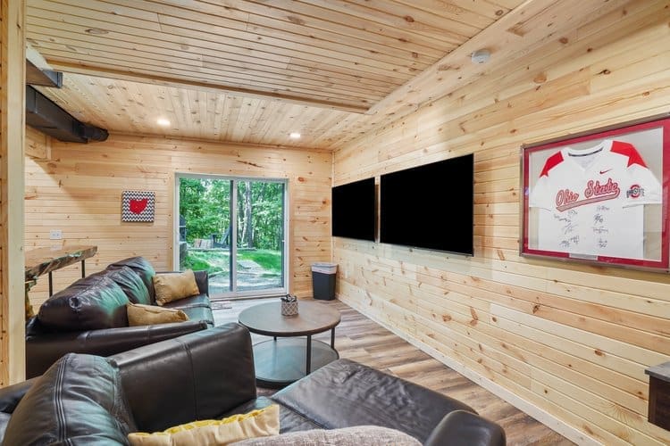 Enjoy watching your favorite show or sporting event on the two side-by-side 65-inch wall-mounted TVs.