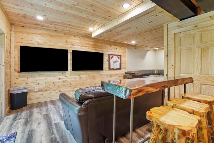 Enjoy watching your favorite show or sporting event on the two side-by-side 65-inch wall-mounted TVs.