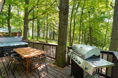 Wraparound deck at Notestone Cabin overlooking private wooded surroundings