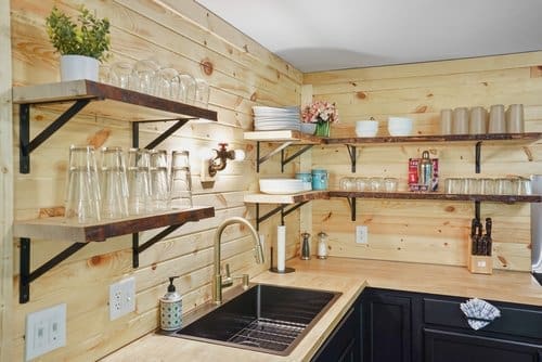 Fully stocked modern kitchen inside Notestone Cabin with open shelving