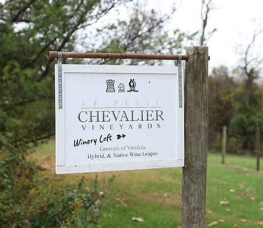 Signboard for Chevalier Vineyards and Farm Winery on a grassy property