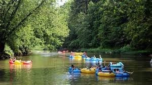 Colorful canoes docked near the river at Hocking Hills Adventures