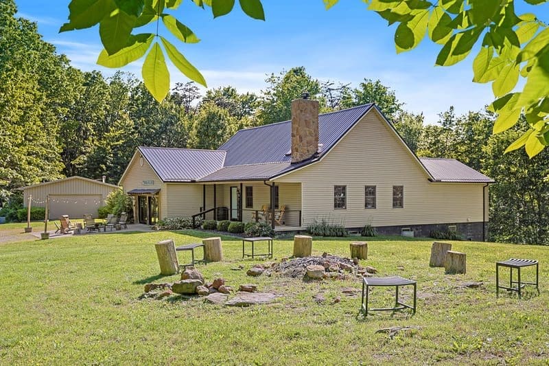Exterior of The Woodland Lodge by The Woodlands at Hocking Hills showing the fire pit area.